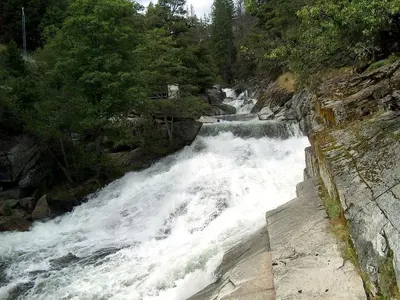 a river with white water rushing down a mountain at Gorgeous Cabin Rental with Spacious Furnished Deck in Pioneer, California in Pioneer