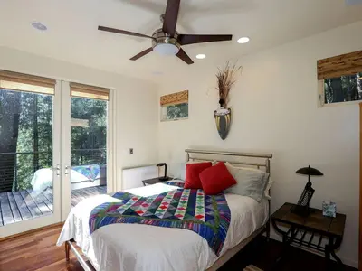 a bedroom with a bed and a ceiling fan at Stunning and Secluded Lakeside Getaway in the Grass Valley of California in Grass Valley