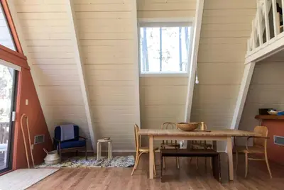 a dining room with a table and chairs at Stunning A-Frame Cabin Rental for Four Guests in Arnold, California in Arnold