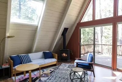 a living room with a couch and a fireplace at Stunning A-Frame Cabin Rental for Four Guests in Arnold, California in Arnold