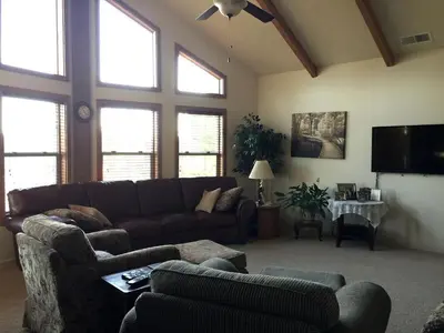 a living room with a couch and a tv at Luxury Cabin Rental with a Fire Pit in Coulterville, California in Coulterville
