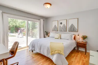 a bedroom with a bed and a large window at 24 Mi to Slopes! Family Reno Home with Outdoor Oasis in Reno