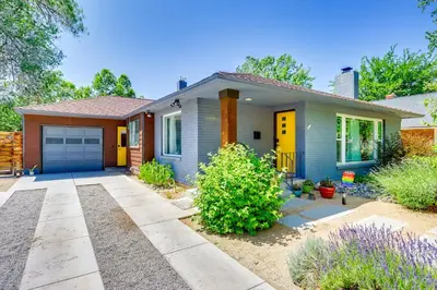 a small house with a yellow door at 24 Mi to Slopes! Family Reno Home with Outdoor Oasis in Reno