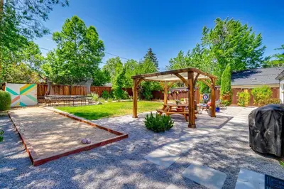 a backyard with a picnic table and a playground at 24 Mi to Slopes! Family Reno Home with Outdoor Oasis in Reno