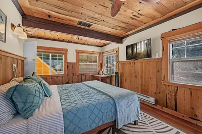 a bedroom with a bed in a room with wooden walls at The Extraordinary Camino Hotel in Camino