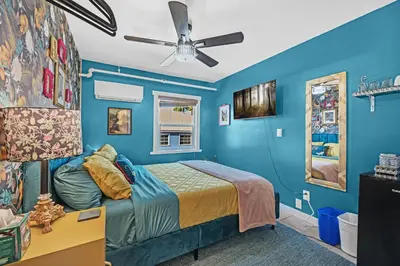 a blue bedroom with a bed and a ceiling fan at The Extraordinary Camino Hotel in Camino