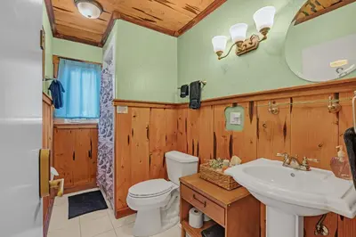 a bathroom with a sink and a toilet and a mirror at The Extraordinary Camino Hotel in Camino