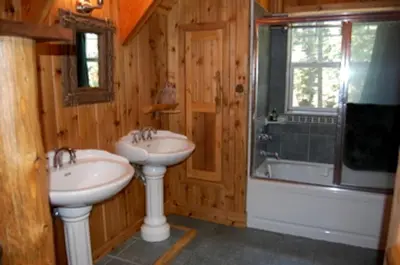 a bathroom with two sinks and a bath tub at Traditional Log Cabin Rental for Couples on the West Shore of Lake Tahoe, California in Tahoe City