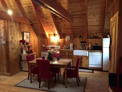 a kitchen with a table and chairs and a refrigerator at Traditional Log Cabin Rental for Couples on the West Shore of Lake Tahoe, California in Tahoe City