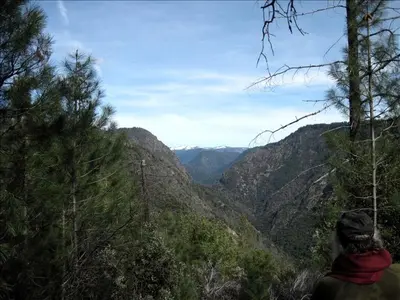 a person standing on a mountain looking at a valley at Country Cabin with Spa Hot Tub and Private Deck near Rollins Lake in California in Gold Run
