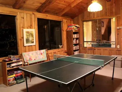 a ping pong table in a living room with a ping pongetitive at Country Cabin with Spa Hot Tub and Private Deck near Rollins Lake in California in Gold Run