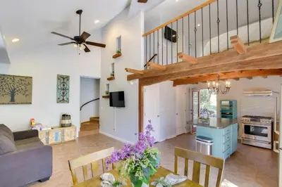 a living room and kitchen with a vaulted ceiling at Walk to Riverfront Beach Kernville Escape in Kernville