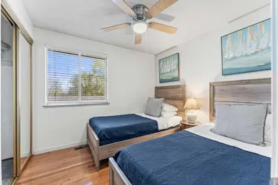 a bedroom with two beds and a ceiling fan at Cozy 3BR Family Home with Patio & BBQ grill Close to Casinos and Shops in Reno