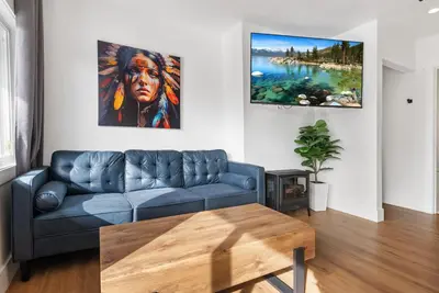 a living room with a blue couch and a table at Experience Zephyr Cove Retreat Relax Enjoy #6 in Zephyr Cove