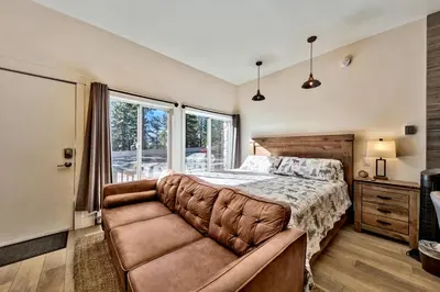 a bedroom with a bed and a large window at First level studio Unit #7 close to everything bike, ski, swim Zephyr Cove! in Zephyr Cove