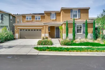 a house with a driveway and a garage at Pool Paradise Spacious Tracy Home with Yard! in Tracy