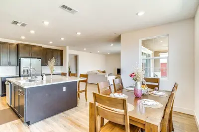 a kitchen and dining room with a table and chairs at Pool Paradise Spacious Tracy Home with Yard! in Tracy