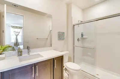 a bathroom with a toilet and a sink and a shower at Pool Paradise Spacious Tracy Home with Yard! in Tracy