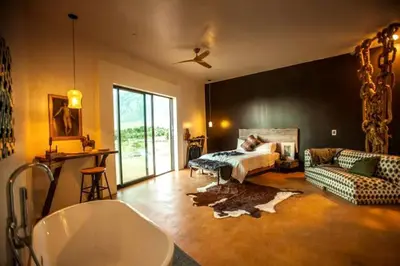 a bathroom with a bedroom with a bed and a couch at Amazing Lone Pine Cabin for Glamping in California in Lone Pine