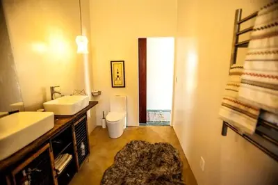 a bathroom with a sink and a toilet in it at Amazing Lone Pine Cabin for Glamping in California in Lone Pine