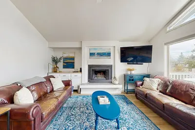 a living room with leather couches and a fireplace at Modern Mountain Escape in South Lake Tahoe