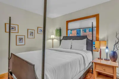 a bedroom with a large bed and a window at Spacious Pet-Friendly Truckee Retreat with Hot Tub in Truckee