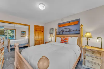 a bedroom with a large bed and a mirror at Spacious Pet-Friendly Truckee Retreat with Hot Tub in Truckee