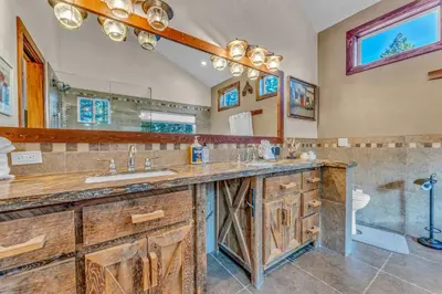 a bathroom with two sinks and a large mirror at Spacious Pet-Friendly Truckee Retreat with Hot Tub in Truckee