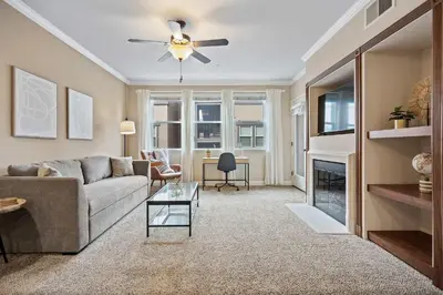 a living room with a couch and a ceiling fan at Luxury 2BR 2BA Apartment with Pool Gym & Theater in Steamboat