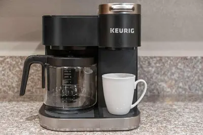 a coffee maker with a cup on a counter at Luxury 2BR 2BA Apartment with Pool Gym & Theater in Steamboat