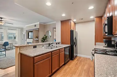 a kitchen with a sink and a refrigerator at Luxury 2BR 2BA Apartment with Pool Gym & Theater in Steamboat