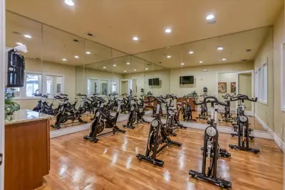 a gym with a lot of treadmills and ellipticals at Luxury 2BR 2BA Apartment with Pool Gym & Theater in Steamboat