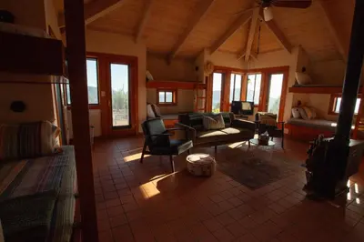 a living room with a couch and a table at Priest Ranch with Guest House and Pool in Big Oak Flat