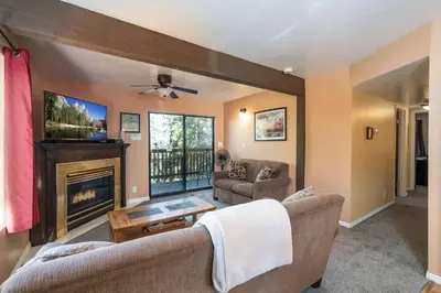a living room with two couches and a fireplace at Yosemite Aviary - Bird's Eye View Awesome Upper Unit in Yosemite West