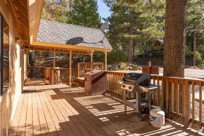 a wooden deck with a bbq and a grill at Yosemite Aviary - Bird's Eye View Awesome Upper Unit in Yosemite West