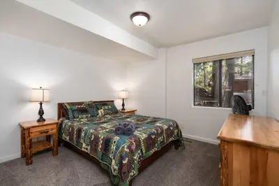 a bedroom with a bed and a desk and a window at Yosemite Aviary and Quail Within Yosemite - 2 Separate Family Units Welcoming Up To 14 Guests in Yosemite West