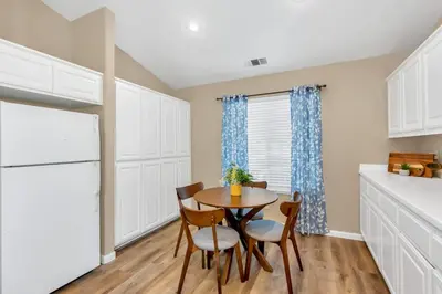 a kitchen with a table and chairs and a refrigerator at University Pastoral - Family Perfect Close to UCM in Merced