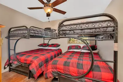a bedroom with two bunk beds and a ceiling fan at A Tuscan Adventure in California 3 BDR Sleeps 8 in Shaver Lake