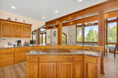 a kitchen with wooden cabinets and a large sink at Gorgeous 5 BDR Traviloli Mountain Retreat for 10 in Shaver Lake