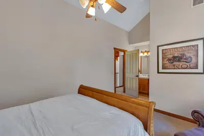 a bedroom with a bed and a ceiling fan at Gorgeous 5 BDR Traviloli Mountain Retreat for 10 in Shaver Lake