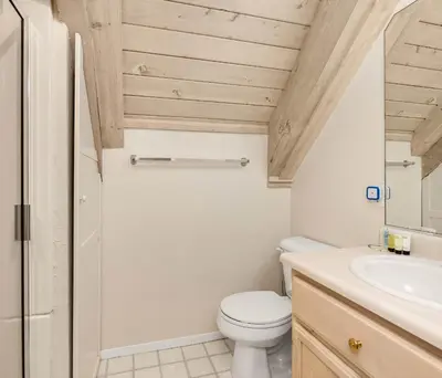 a bathroom with a toilet and a sink at Cavu Cabin - A Classic Mountainside Escape in Shaver Lake