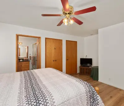 a bedroom with a bed and a ceiling fan at Granite View Lodge - Minutes from Water in Shaver Lake