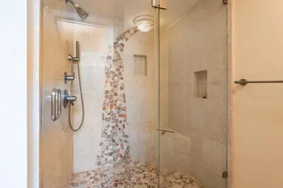 a bathroom with a shower with a glass door at Happy Days Retreat with Private Pool in Bass Lake Annex