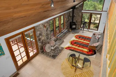 an overhead view of a living room with a stone fireplace at Happy Days Retreat with Private Pool in Bass Lake Annex