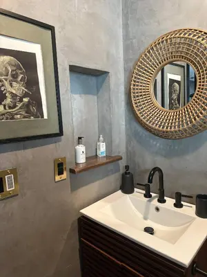 a bathroom with a sink and a mirror at River Magic - Riverfront Family Fun & Lux Design in Three Rivers