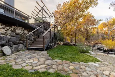 a set of stairs leading up to a house at River Soul – Riverfront Luxury & Stunning Views in Three Rivers