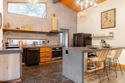 a large kitchen with a counter and a counter top at River Soul – Riverfront Luxury & Stunning Views in Three Rivers