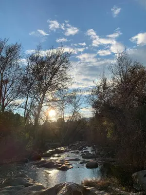 a river with the sun setting in the background at Sequoia Arquitectural Wonder with Hot Tub & Views in Three Rivers