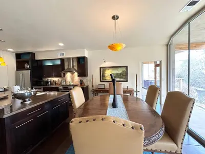 a kitchen and dining room with a wooden table and chairs at Sequoia Arquitectural Wonder with Hot Tub & Views in Three Rivers