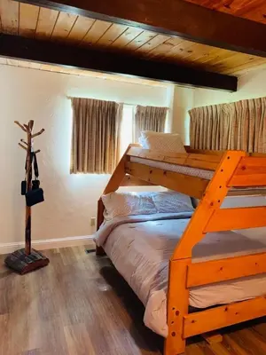 a bedroom with two bunk beds and a cross at Serenity View, Peaceful & Cheerful 3BD Cabin in Groveland